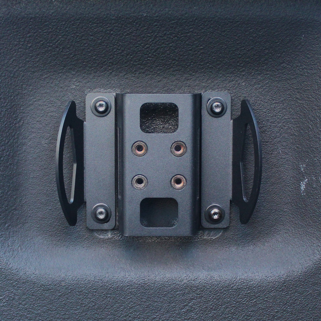 Black metal clip or fastener on a textured gray surface