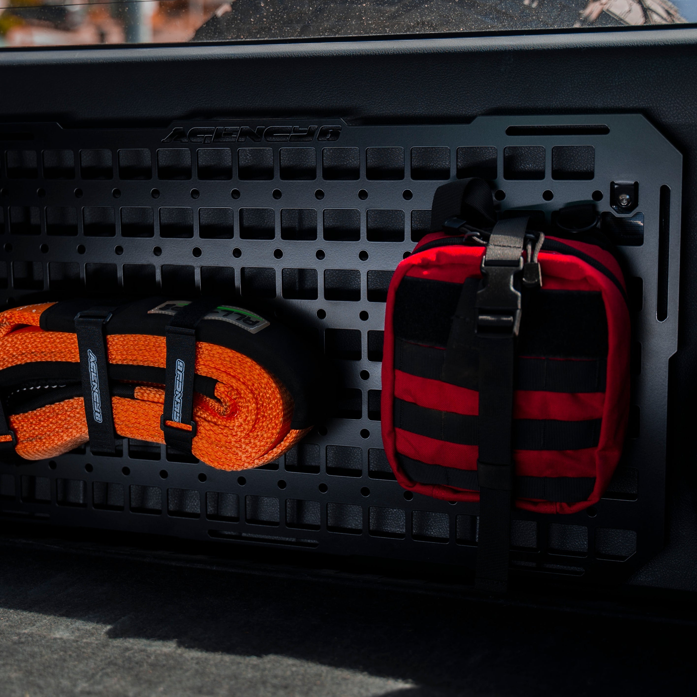Orange and black straps on a black cargo organizer with 'Pacifica' branding.
